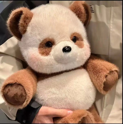 Plush panda bear held by a person with a neutral background