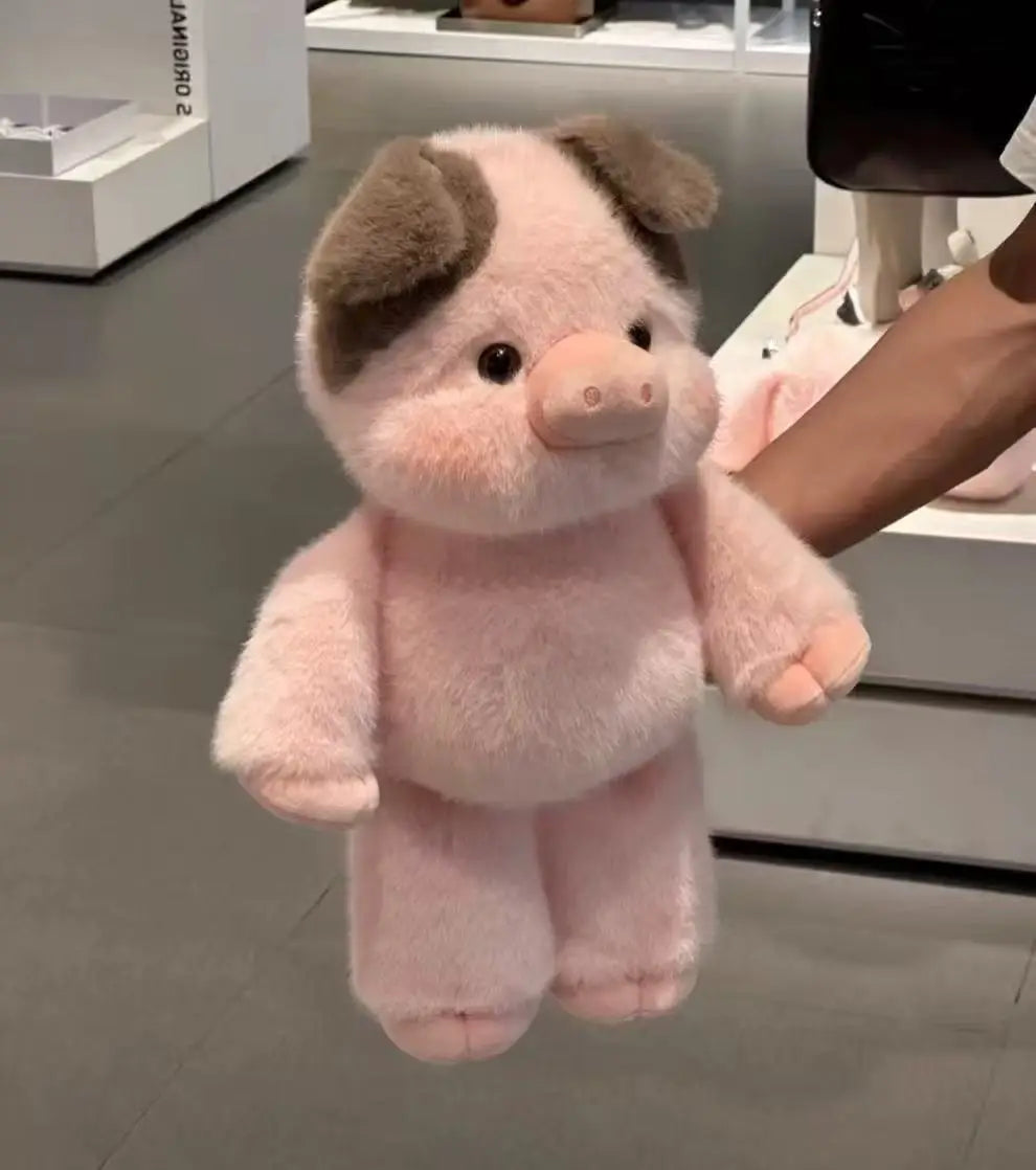 Pink plush pig toy held by a person in an indoor setting